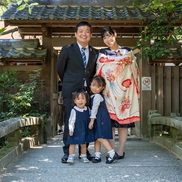 お宮参りの記念に神社で撮影したご家族の集合写真
